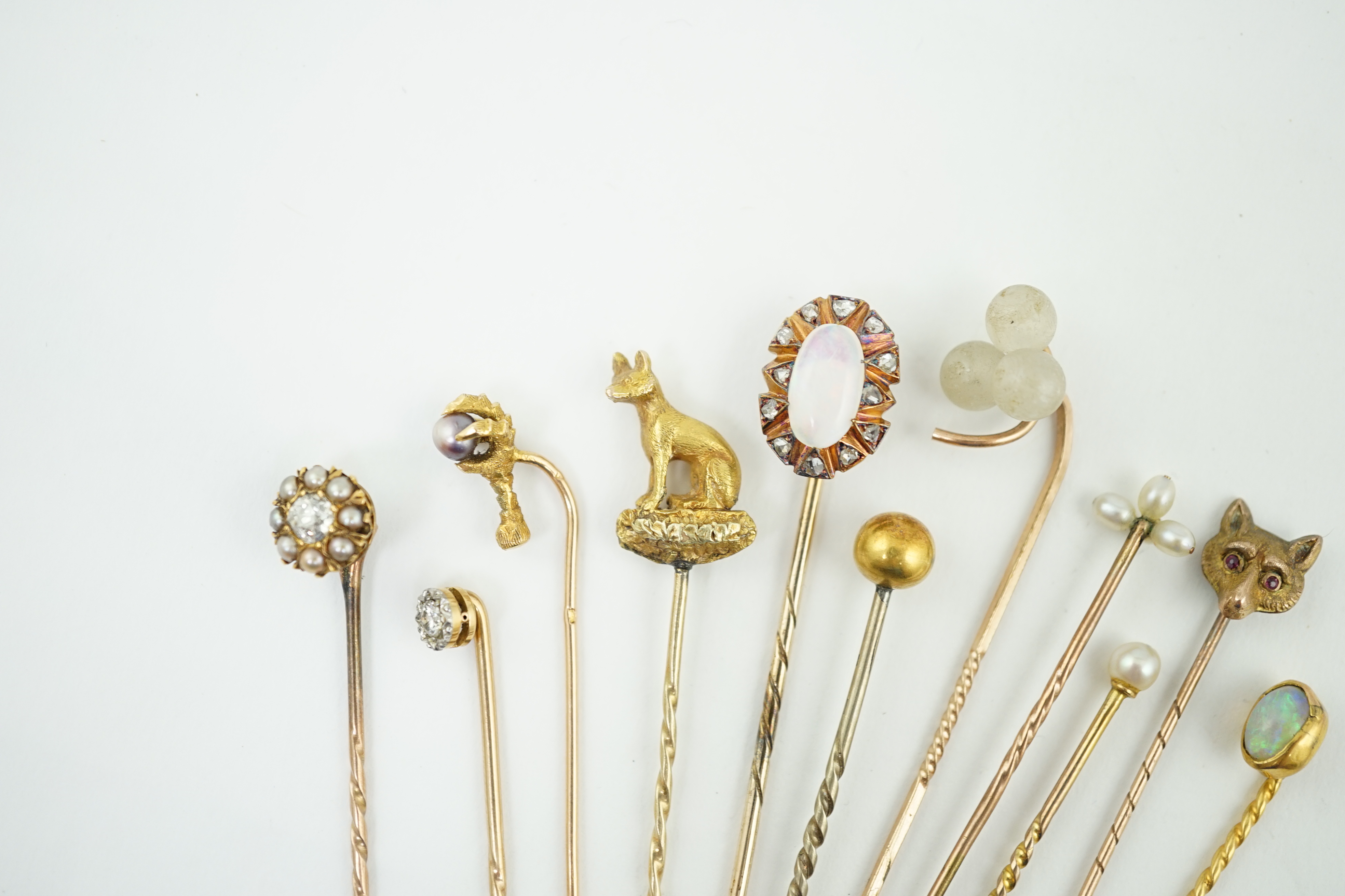 A collection of eleven assorted early 20th century and later stick pins